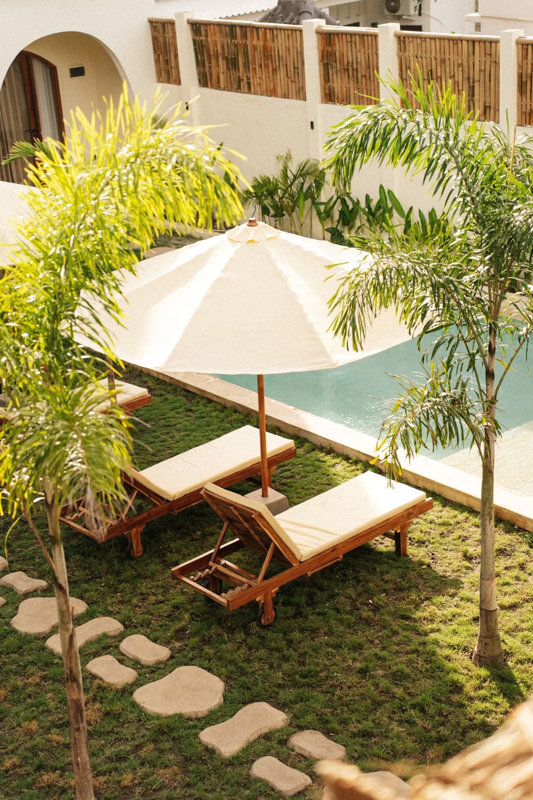 Sun loungers and parasol beside the pool